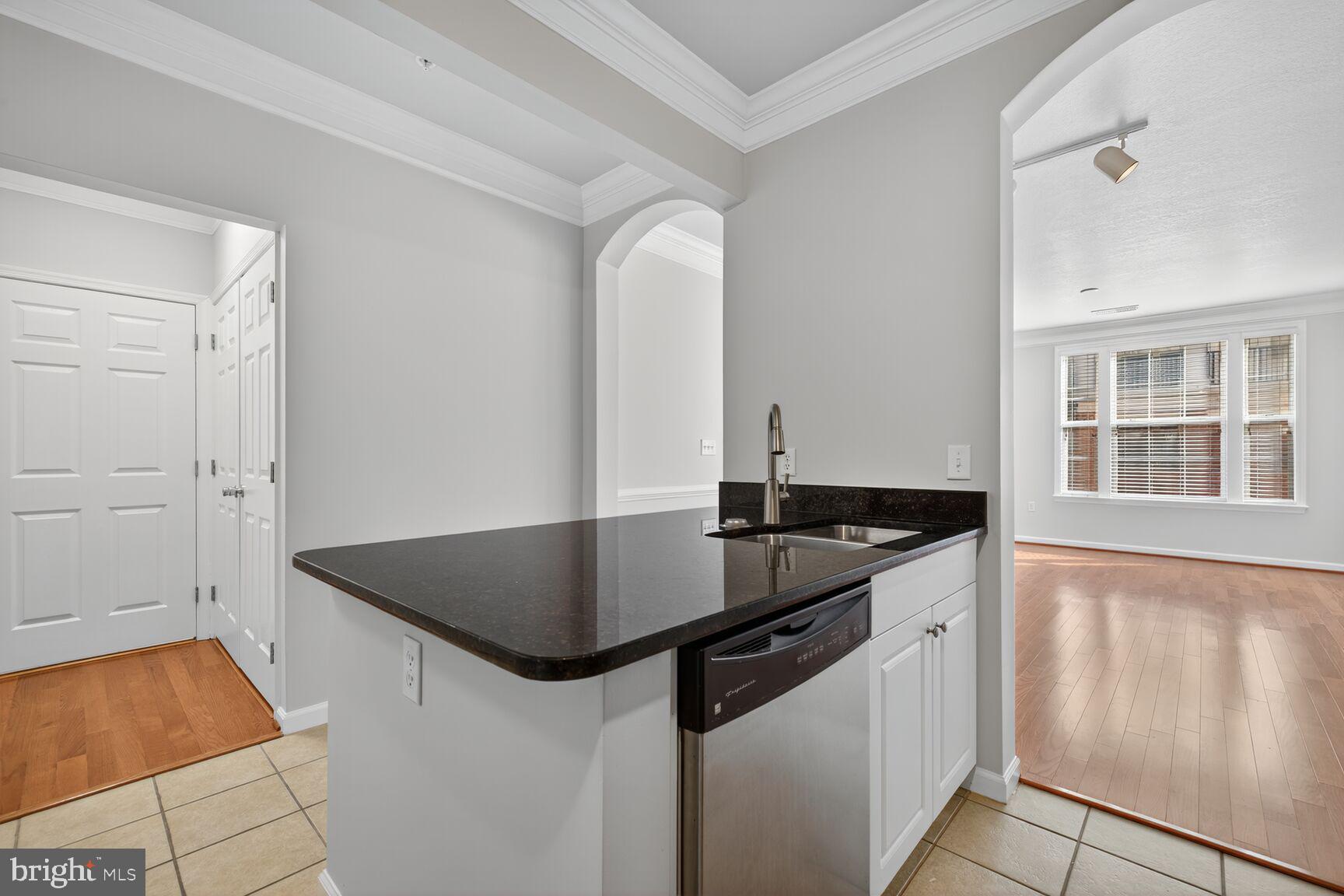 7 Granite Place, Unit 215 Gaithersburg, MD 20878 - Photo 13 of 36 a kitchen with stainless steel appliances granite countertop a sink and a stove