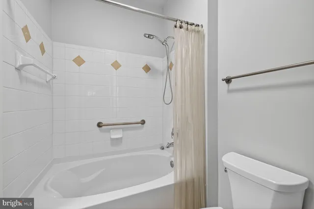 a white bath tub with a shower curtain