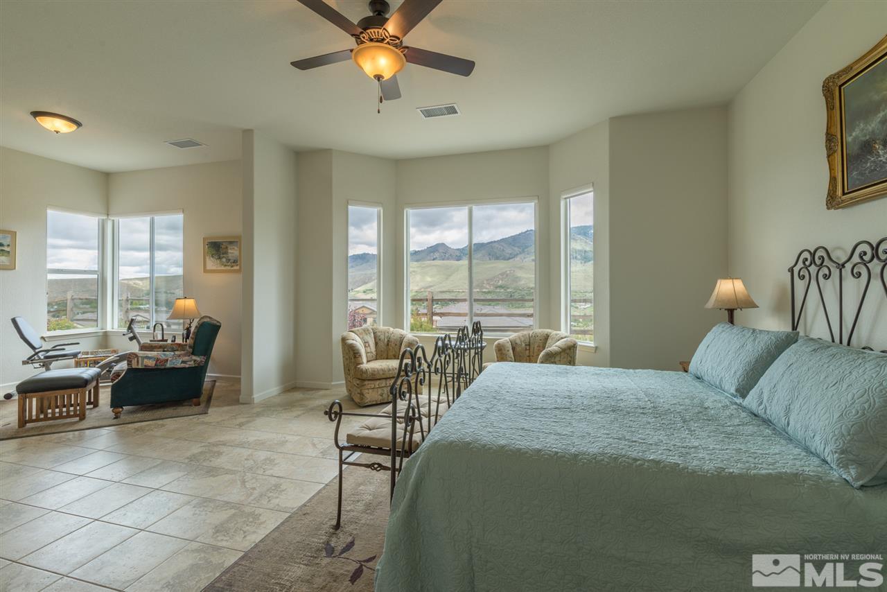 1255 Wakefield Trail Reno, NV 89523 - Photo 16 of 25 a bedroom with a bed and a chandelier