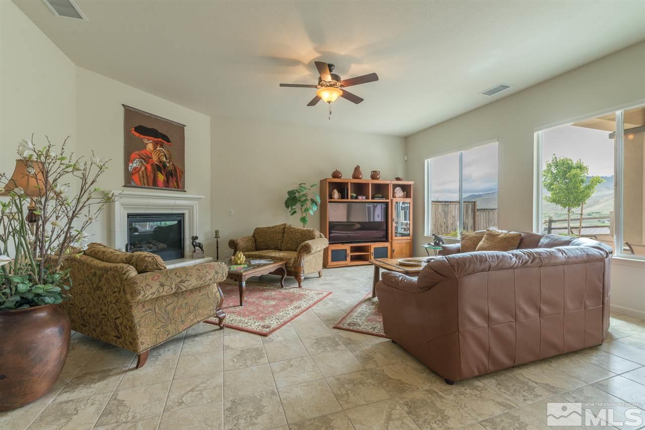 1255 Wakefield Trail Reno, NV 89523 - Photo 6 of 25 a living room with furniture a fireplace and a large window