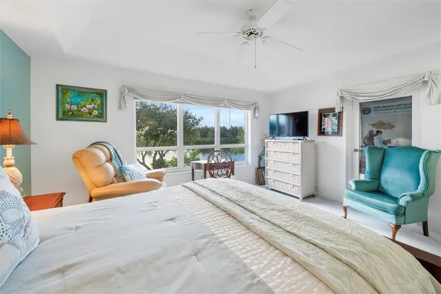 a bedroom with furniture and a large window