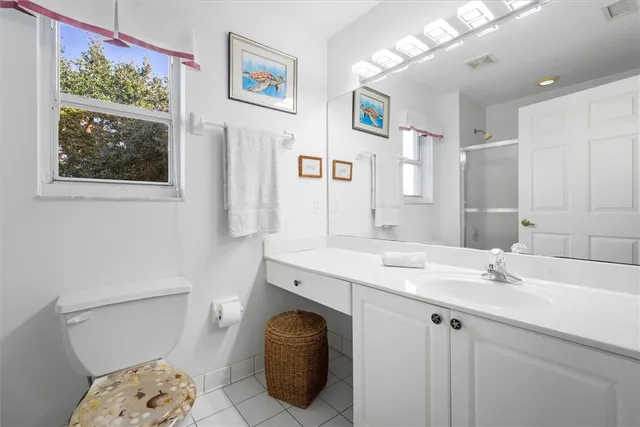 a bathroom with a sink toilet and a mirror