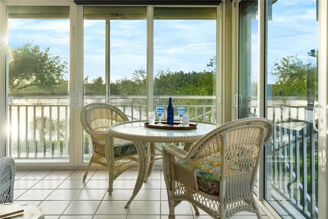 a view of a city from a dining room with a table and chairs