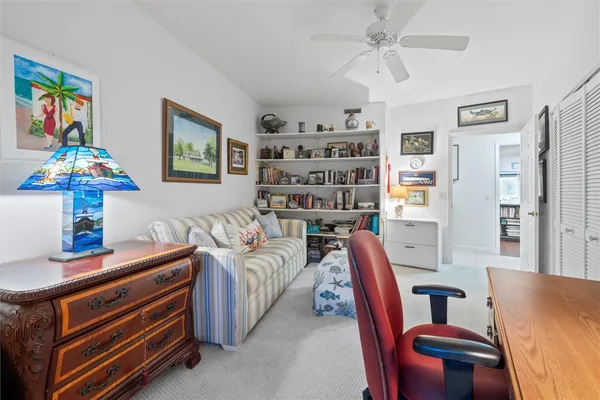 a living room with furniture and a lamp