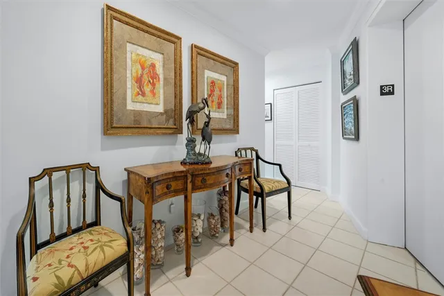 a view of a hallway with furniture and workspace