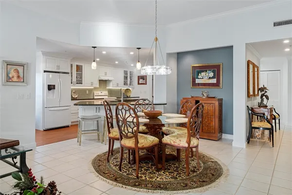 a dining room with furniture a rug and painting
