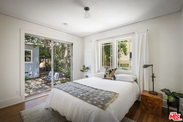 a bedroom with a large bed and a large window