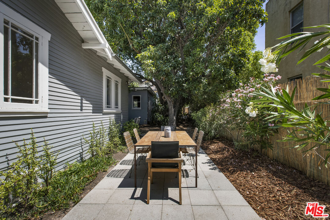 3865 Brunswick Avenue Los Angeles, CA 90039 - Photo 31 of 44 a view of a patio with table and chairs and potted plants