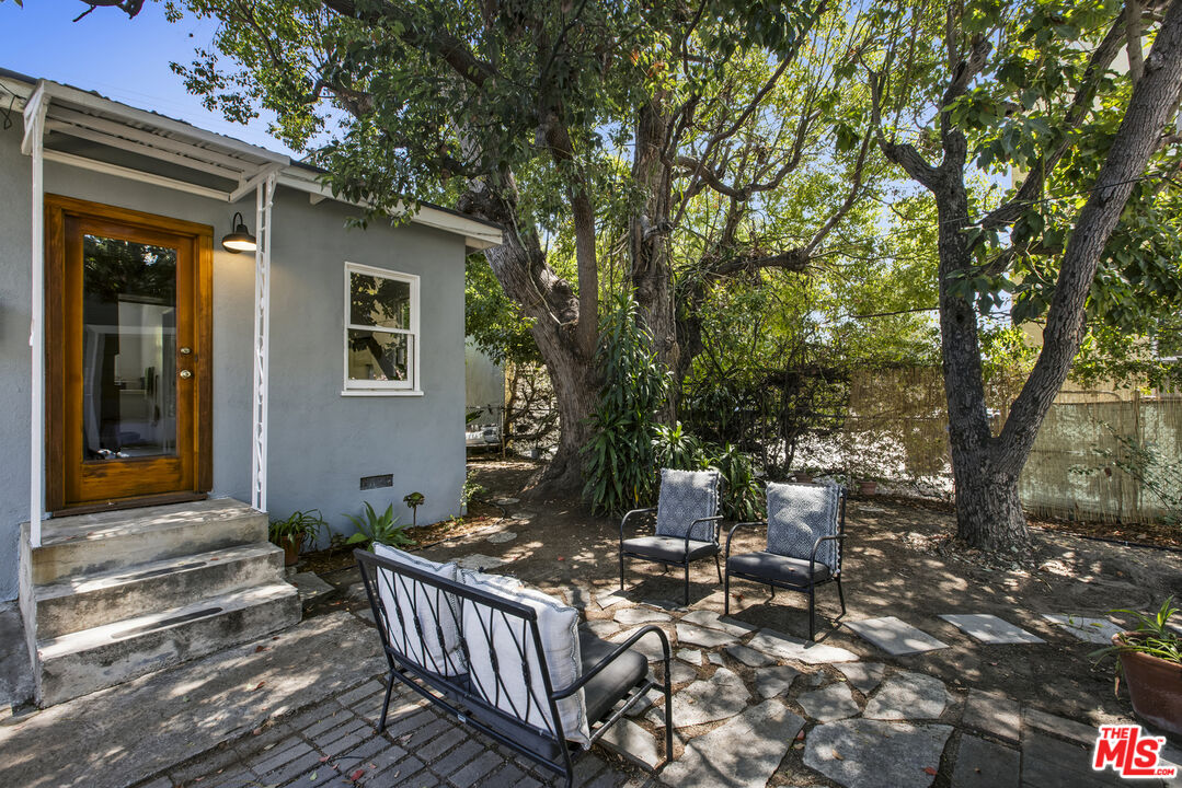 3865 Brunswick Avenue Los Angeles, CA 90039 - Photo 33 of 44 a view of a patio with table and chairs and wooden fence