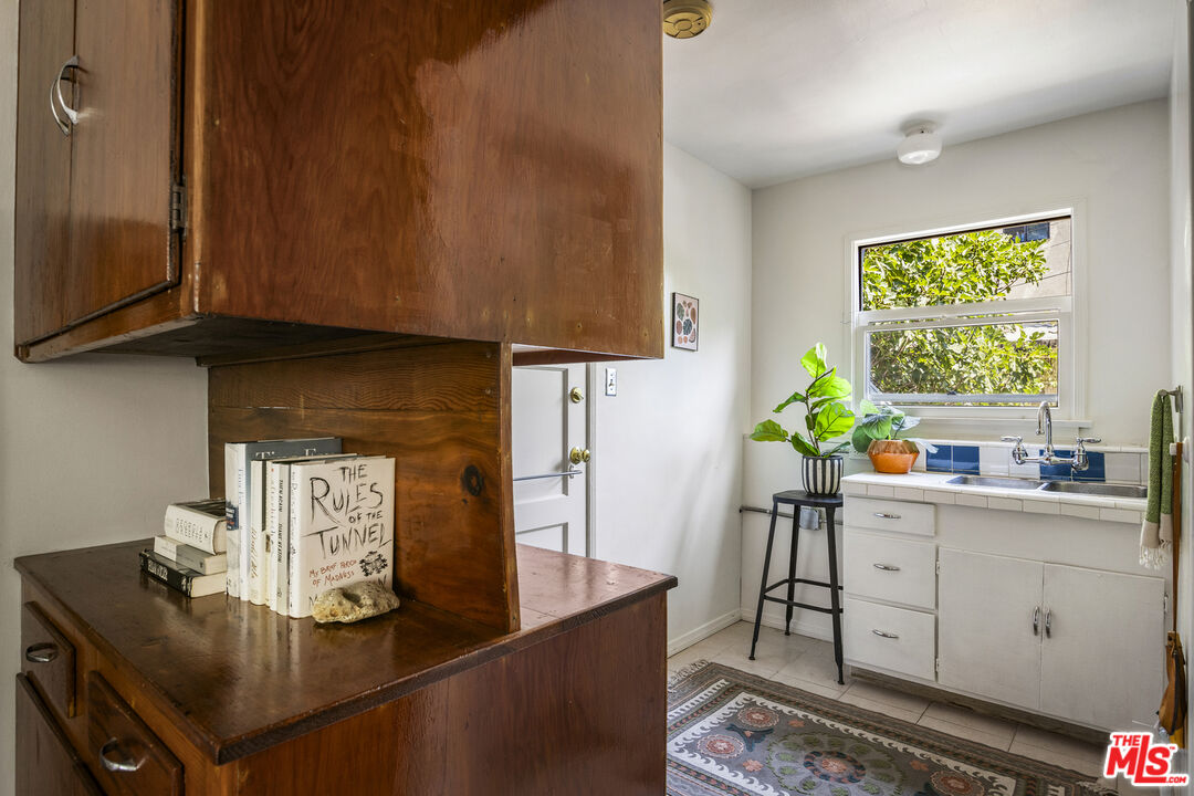 3865 Brunswick Avenue Los Angeles, CA 90039 - Photo 36 of 44 a kitchen with stainless steel appliances granite countertop a table and a cabinets
