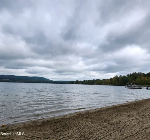 a view of swimming pool with outdoor seating and trees