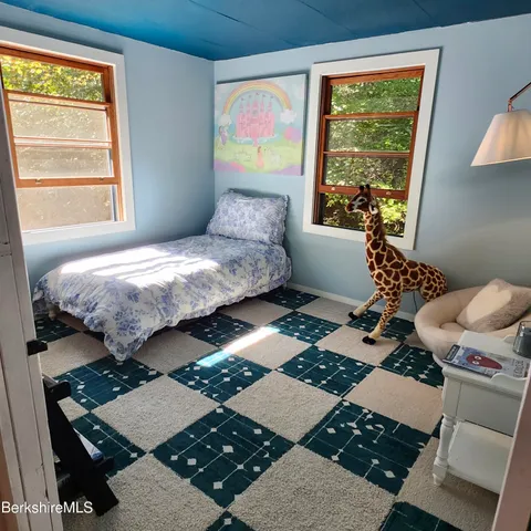 a bedroom with two beds and a window