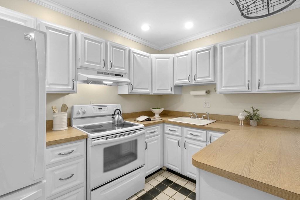 857 Beacon Street, Unit 34 Boston, MA 02215 - Photo 11 of 26 a kitchen with white cabinets and white appliances