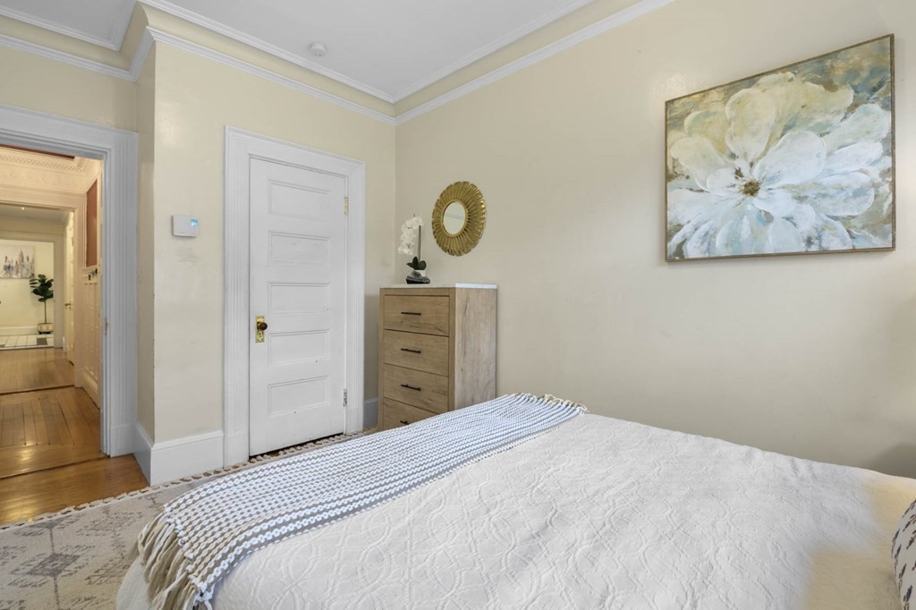 857 Beacon Street, Unit 34 Boston, MA 02215 - Photo 16 of 26 a bedroom with a bed and painting on the wall