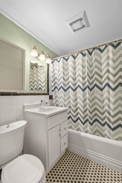 857 Beacon Street, Unit 34 Boston, MA 02215 - Photo 17 of 26 a bathroom with a sink a toilet and shower curtain