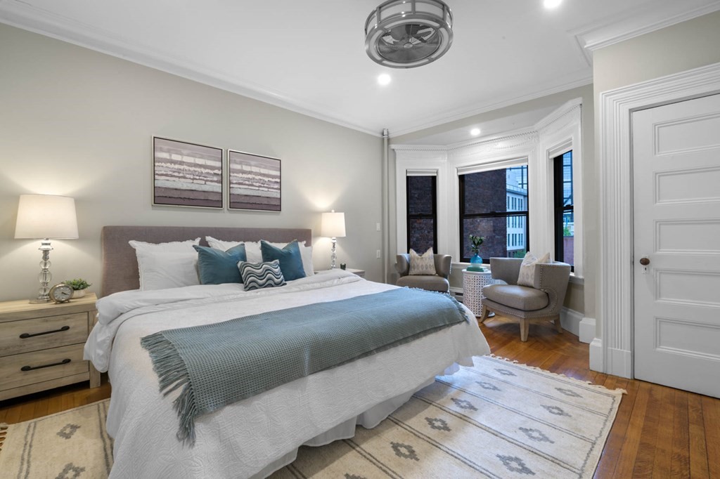 857 Beacon Street, Unit 34 Boston, MA 02215 - Photo 18 of 26 a bedroom with a large bed and a chandelier