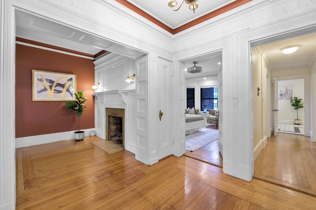 857 Beacon Street, Unit 34 Boston, MA 02215 - Photo 6 of 26 a view of a hallway view with wooden floor and a fireplace