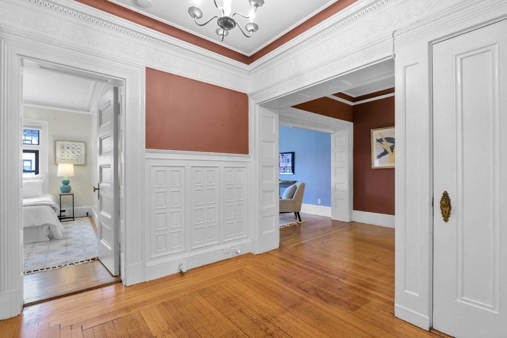 857 Beacon Street, Unit 34 Boston, MA 02215 - Photo 7 of 26 a view of a hallway view with wooden floor and staircase