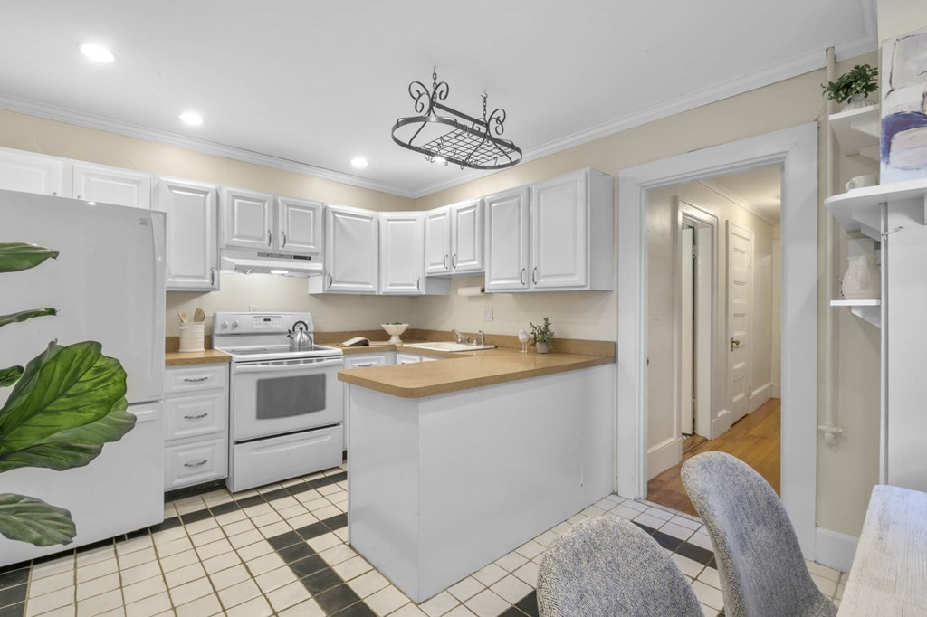 857 Beacon Street, Unit 34 Boston, MA 02215 - Photo 10 of 26 a kitchen with a sink cabinets and window