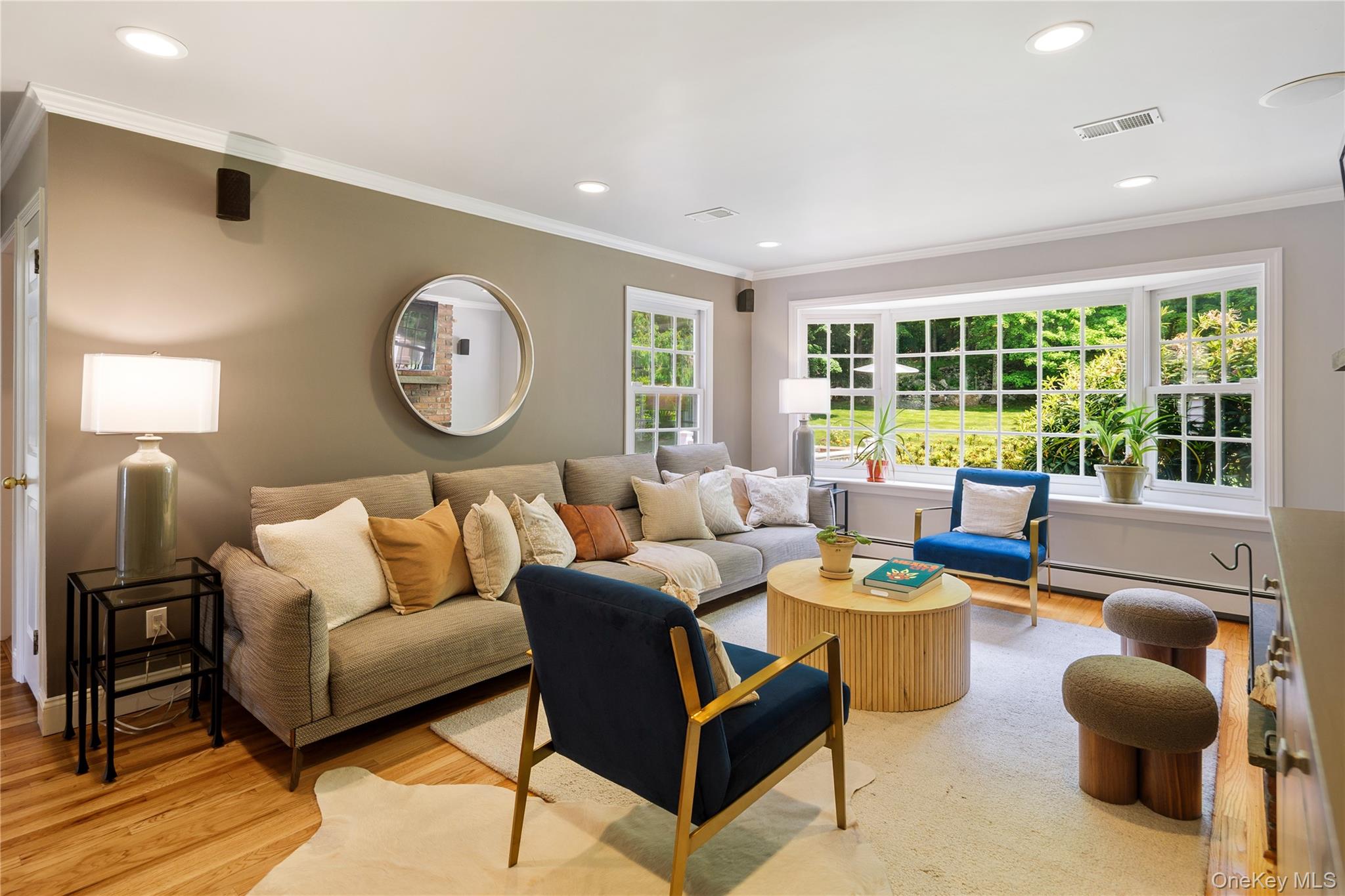 16 Fox Den Road Mount Kisco, NY 10549 - Photo 19 of 44 Family room, oak floors, raised hearth fireplace, wall of windows to backyard, recessed lighting, crown molding, open to eat-in kitchen
