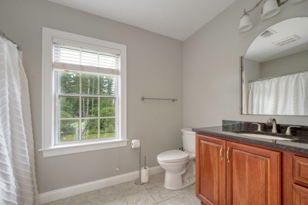 182 Jean Carol Road Abington, MA 02351 - Photo 19 of 38 a bathroom with a granite countertop toilet a sink and a window