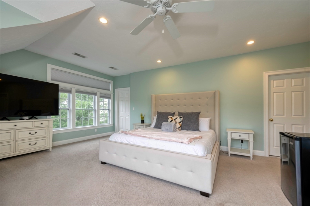 182 Jean Carol Road Abington, MA 02351 - Photo 20 of 38 a bedroom with a bed and a flat screen tv