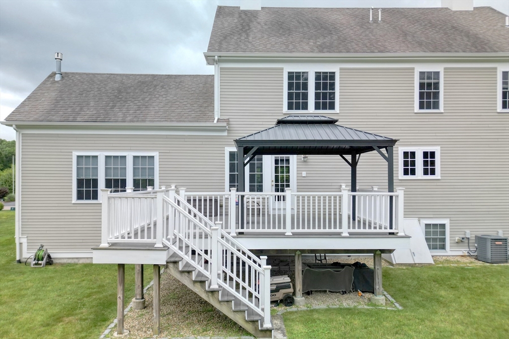 182 Jean Carol Road Abington, MA 02351 - Photo 5 of 38 a view of a house with a deck and a yard