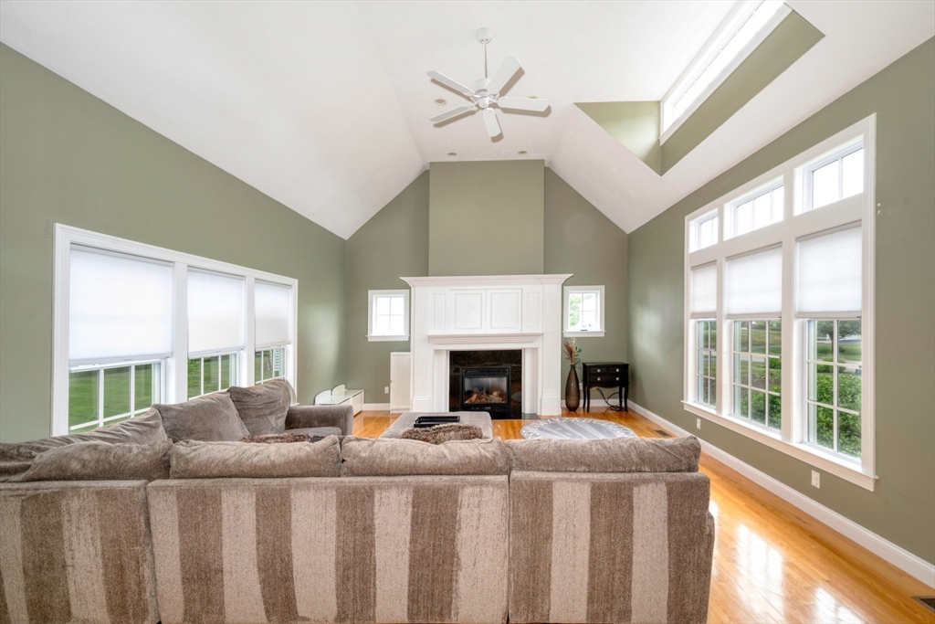 182 Jean Carol Road Abington, MA 02351 - Photo 10 of 38 a bedroom with furniture a fireplace and a large window