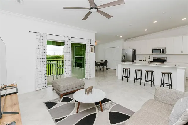 a dining room with furniture and a floor to ceiling window