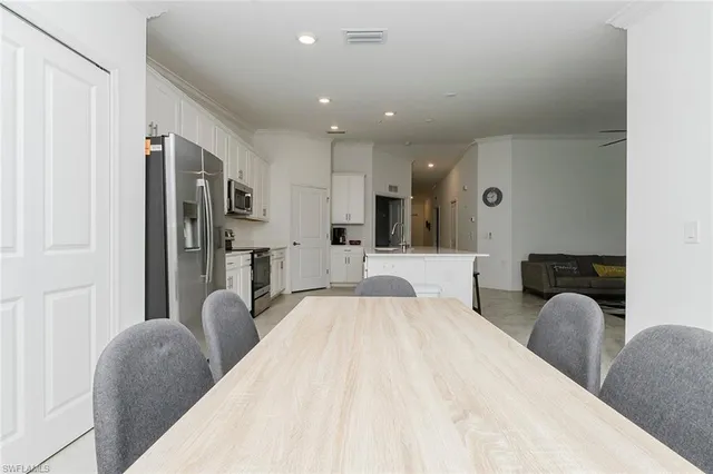 a spacious bedroom with a bed a couch and a view mirror