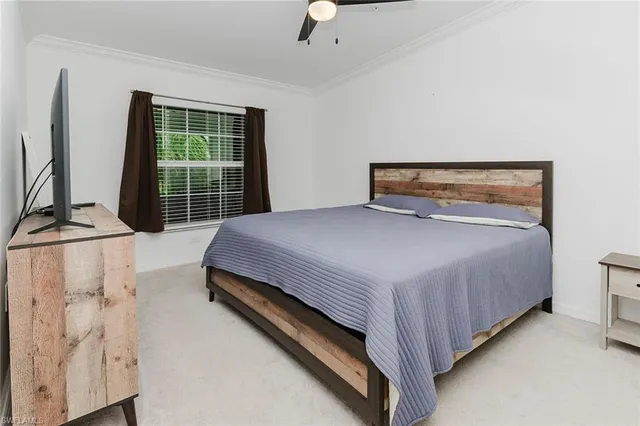 a bedroom with a bed and a window with outer view