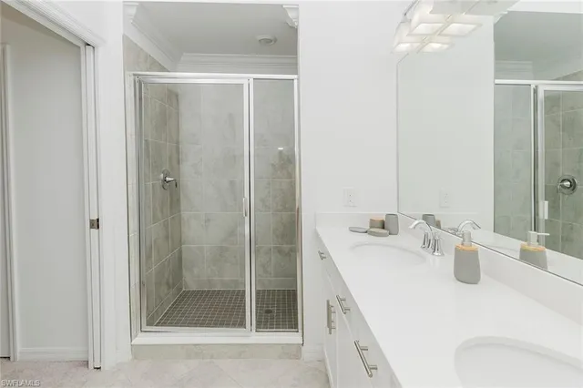 a bathroom with a shower a sink and mirror