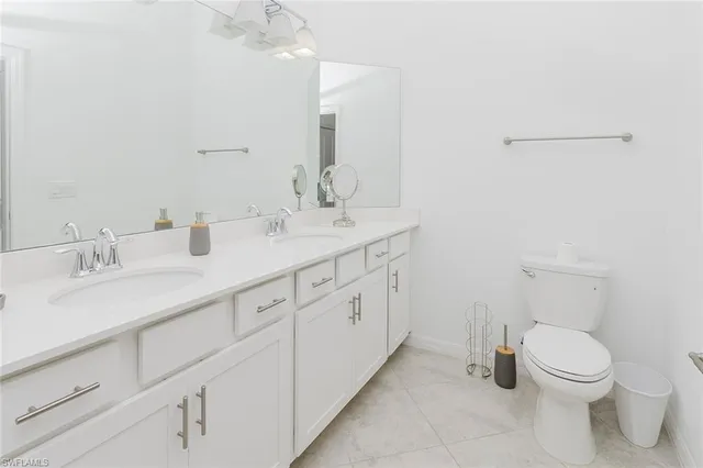 a spacious bathroom with a toilet sink and mirror