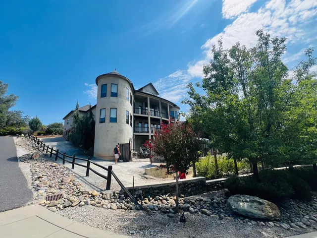 a front view of a house with yard and seating area