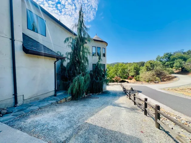 a backyard of a house with barbeque oven table and chairs