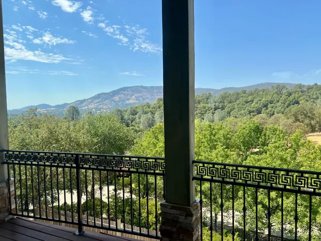 a view of a forest from a balcony