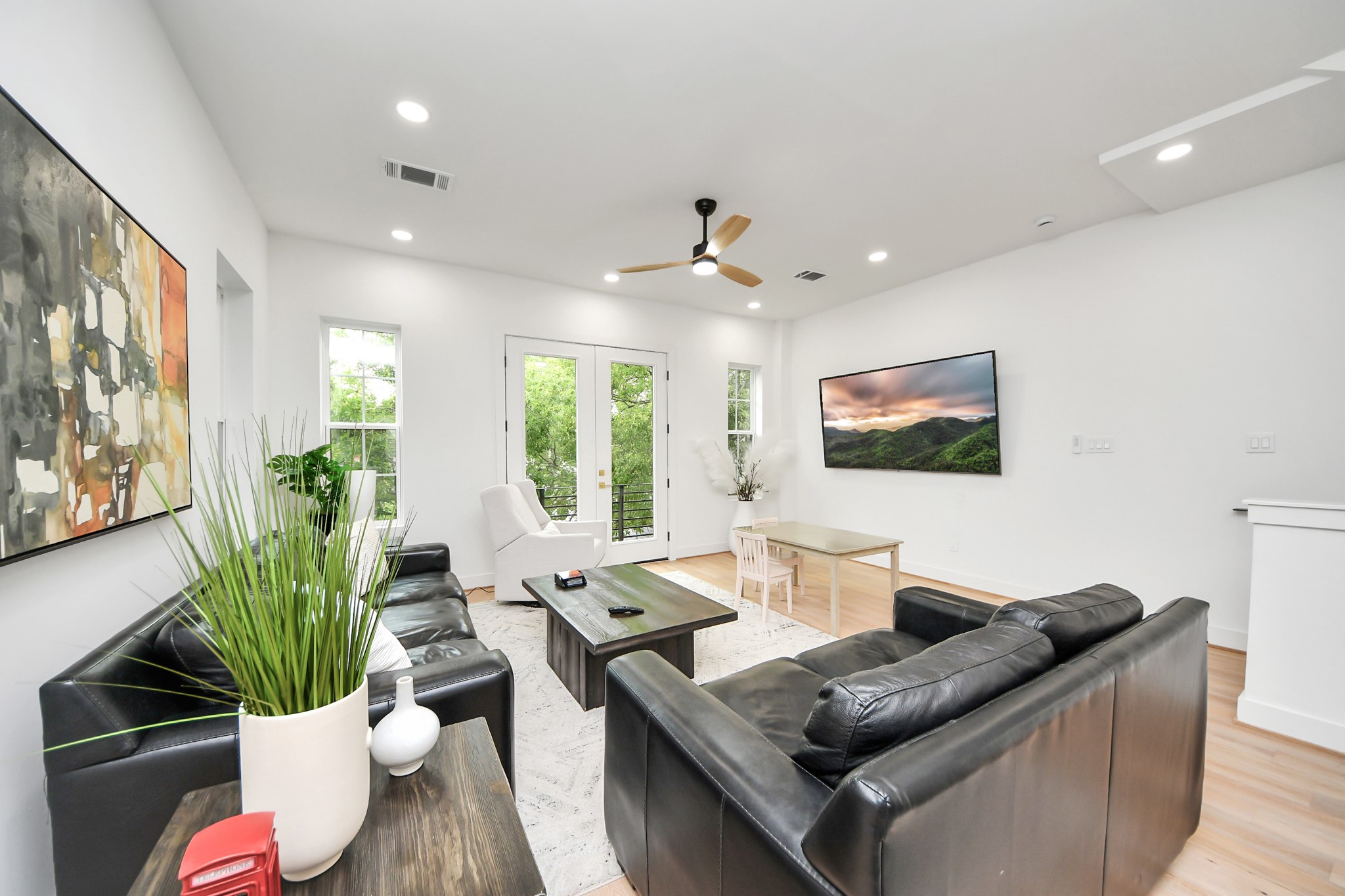 2211 Bevis Street Houston, TX 77008 - Photo 12 of 34 Living area is light and bright with large windows that open, and two balconies.