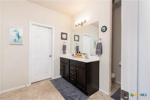 a bathroom with a glass shower door