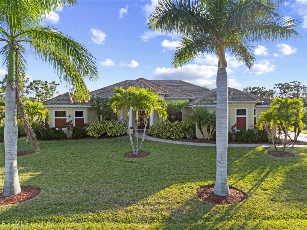 6057 Calusa Rdg Trail Bokeelia, FL 33922 - Photo 36 of 45 a front view of a house with garden