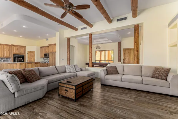 a kitchen with stainless steel appliances kitchen island granite countertop a refrigerator and a sink