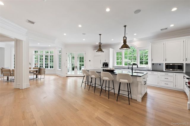 a kitchen with lots of counter and chairs