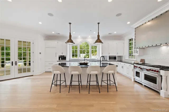 a large kitchen with a table and chairs