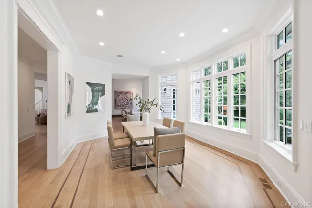 a dining room with furniture and wooden floor