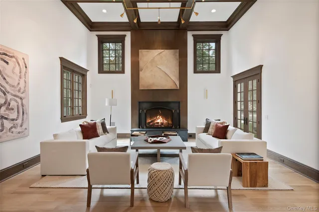 a living room with furniture a fireplace and wall paintings