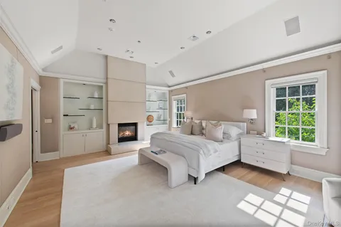 a spacious bedroom with a bed and a fireplace