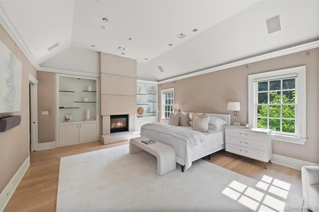 a spacious bedroom with a bed and a fireplace