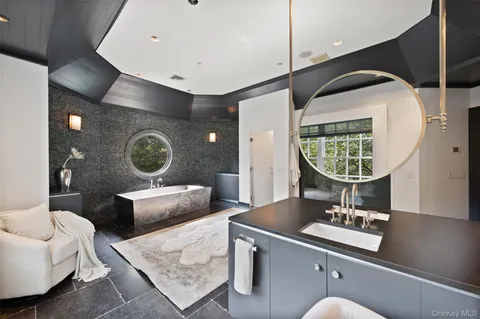 a living room with a couch and a mirror