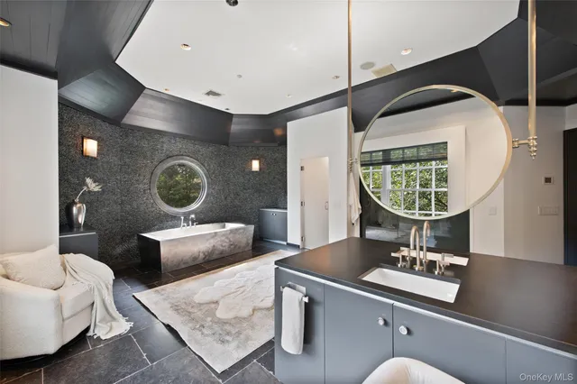 a living room with a couch and a mirror