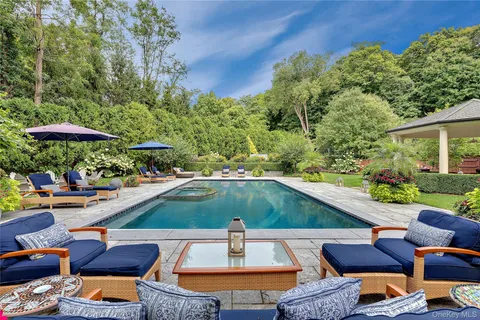 an outdoor space with patio lots of furniture and umbrella