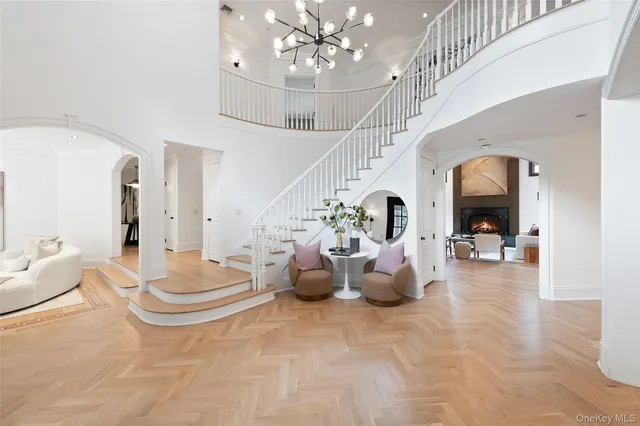 a living room with furniture and a chandelier